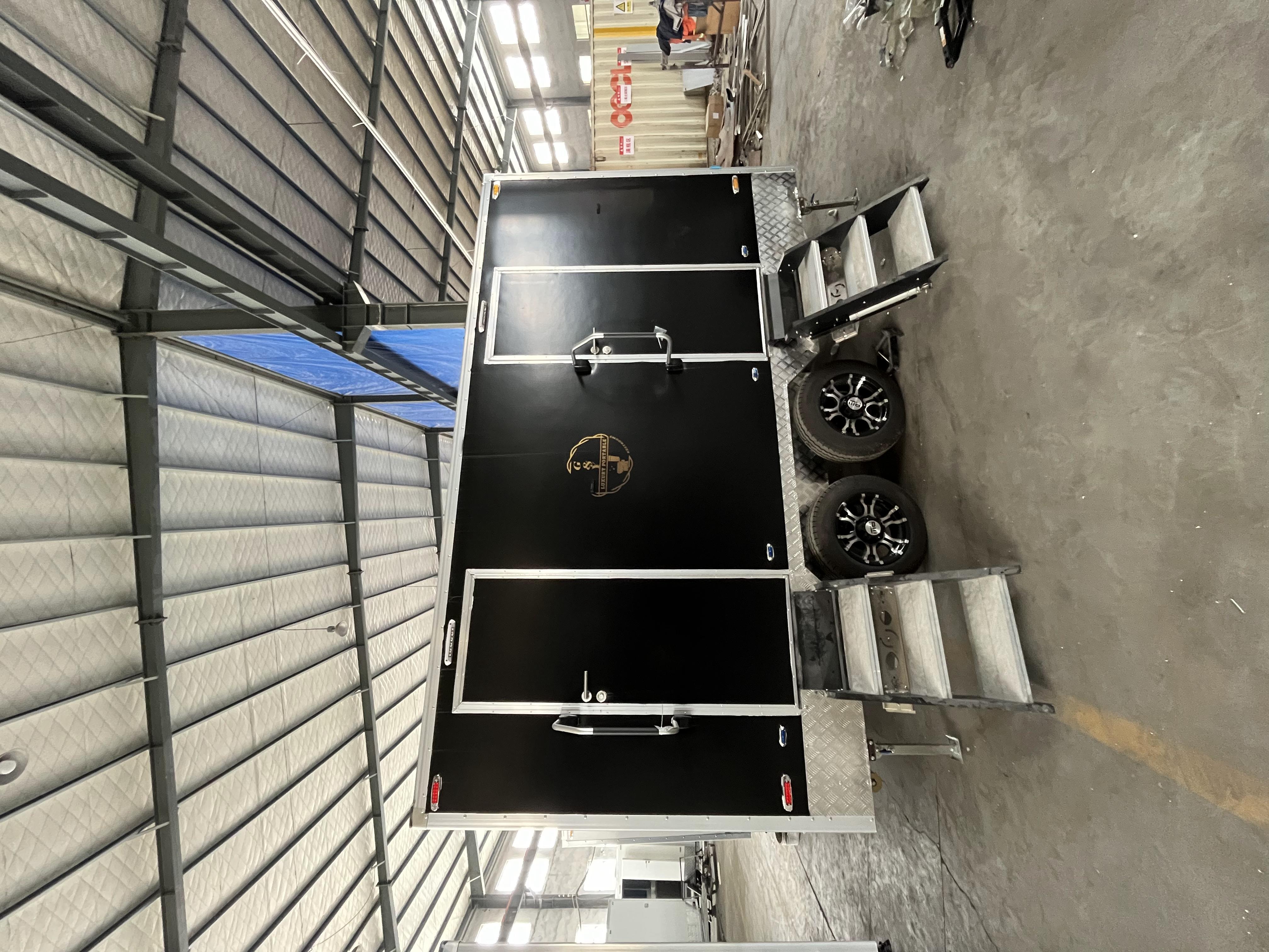 Two toilets with black stickers, creatively designed double-person mobile toilets