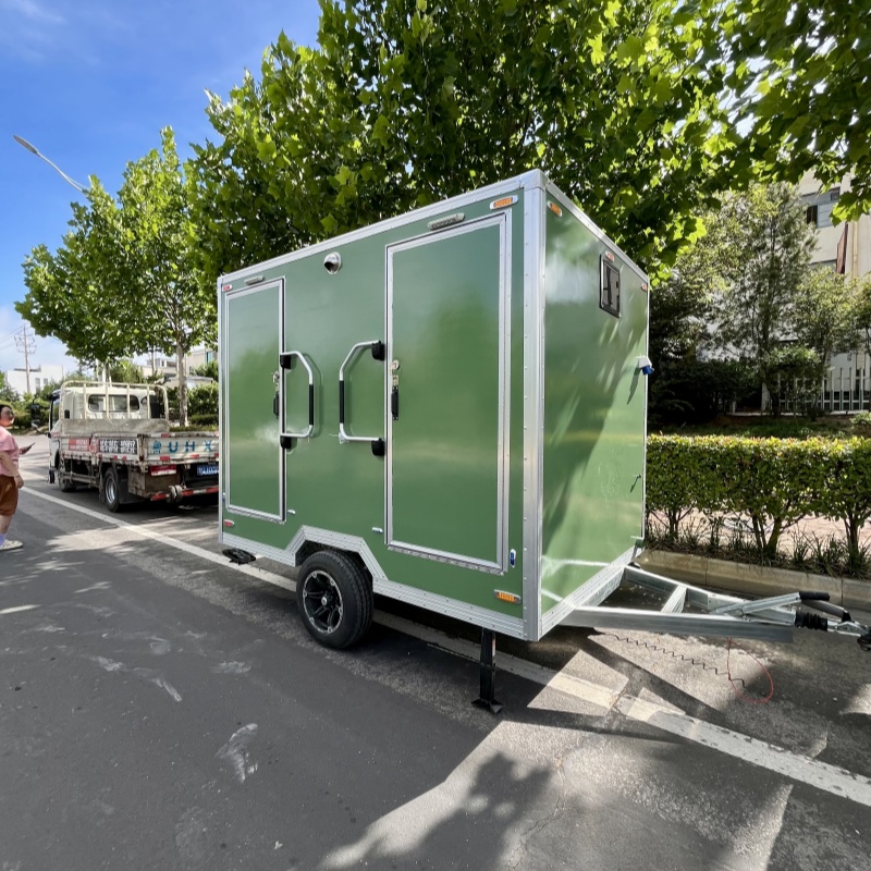 Convenient choice: Green double-room portable toilet trailer, ready to move as needed