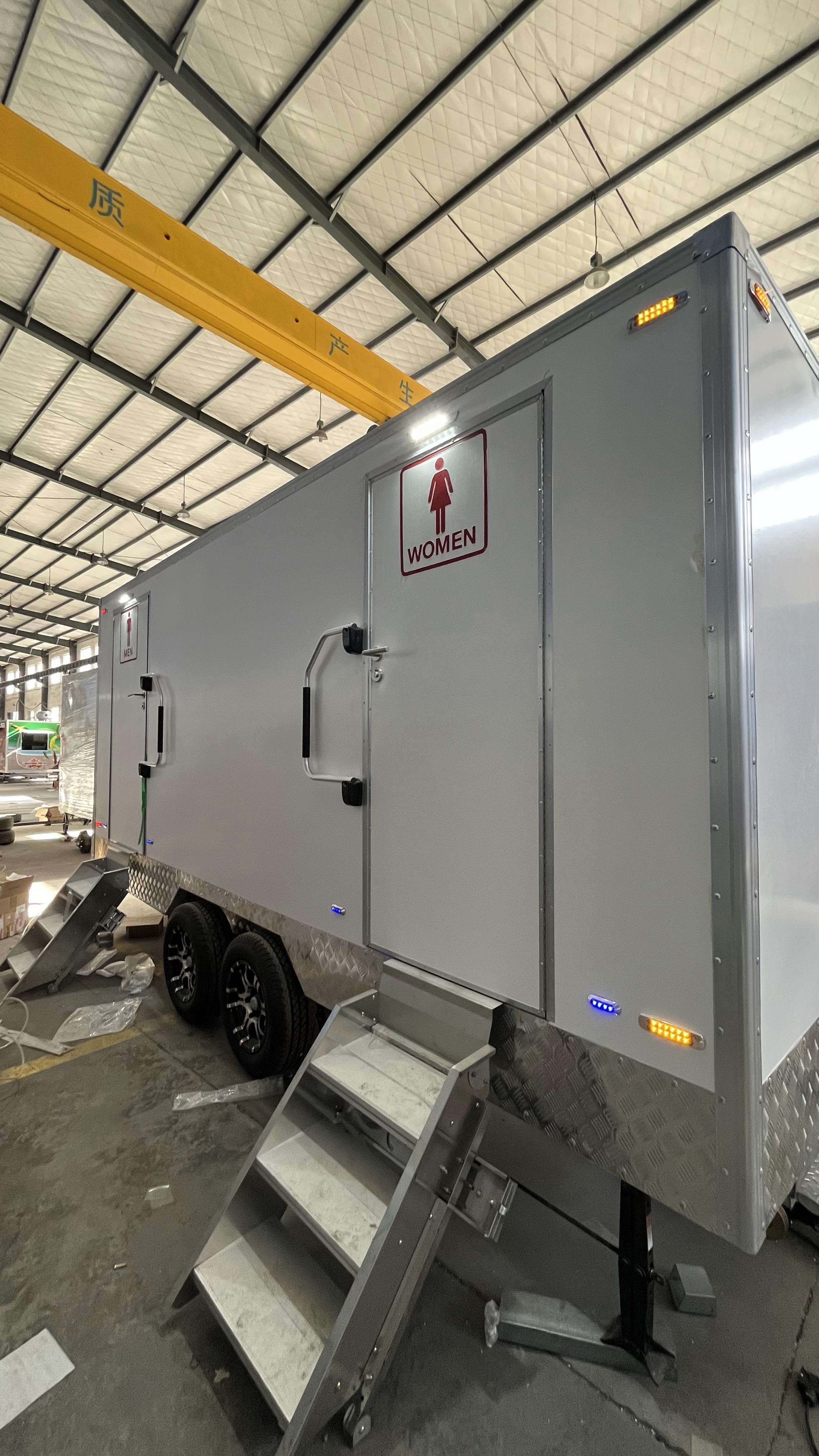 Outdoor double-room mobile toilet trailer with clear male and female markings, flexible deployment of emergency restrooms