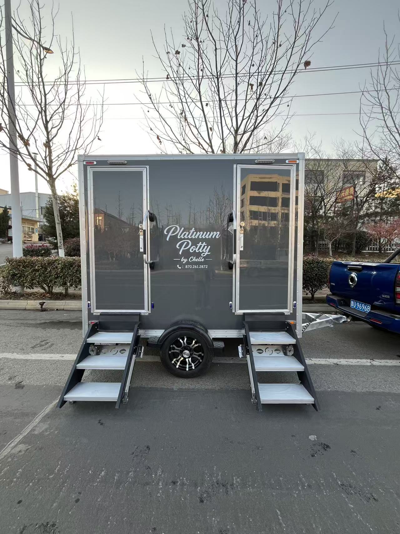 High-end metallic grey mobile toilet trailer: Towable multi-compartment outdoor public restroom with steps