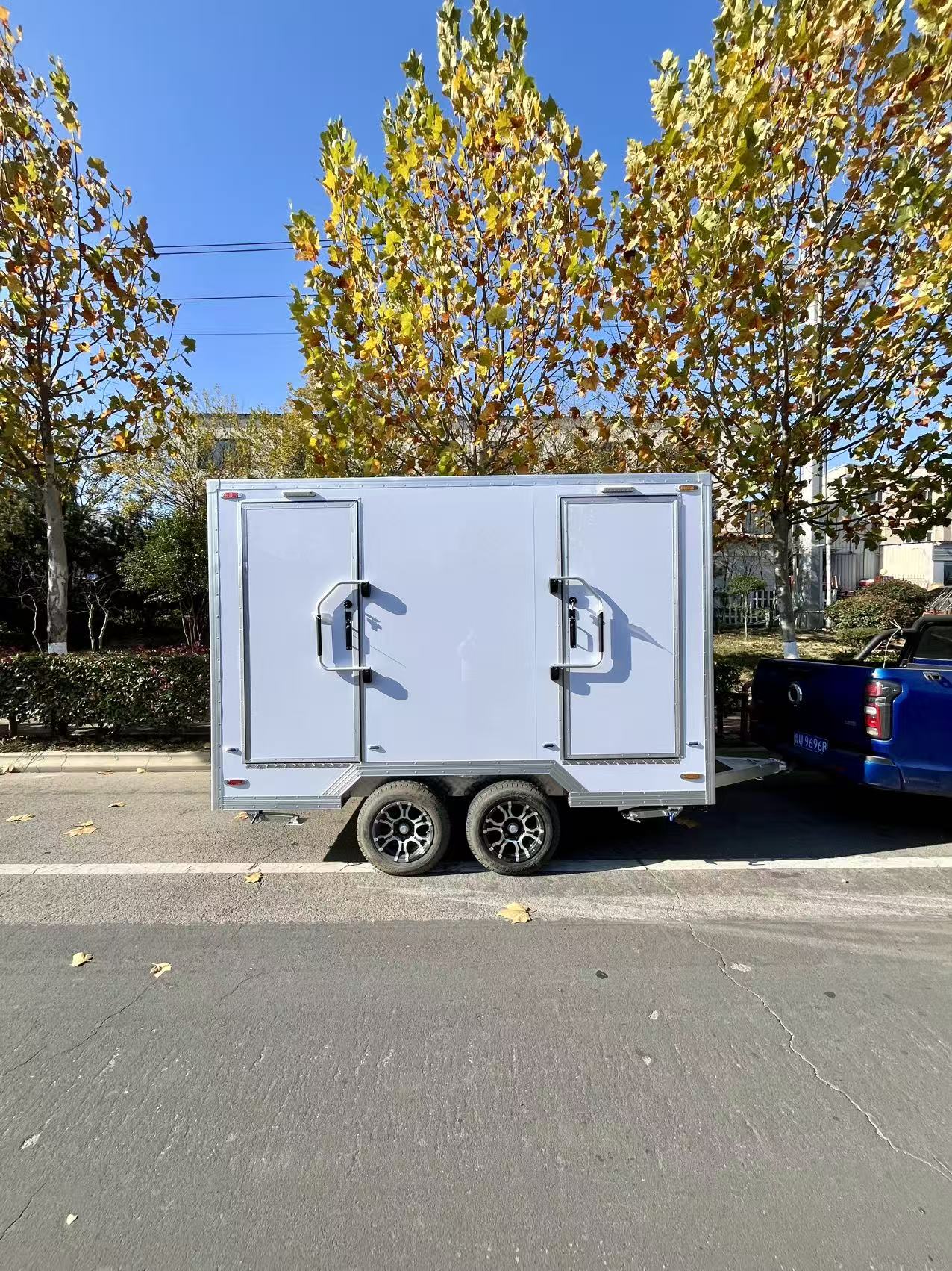 Sleek Dual-Compartment Towable Restroom - Portable Mobile Toilet Trailer with Heavy-Duty Wheels for Outdoor Use